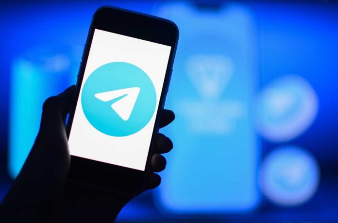 shutterstock_2509651621.jpg A smartphone displaying the Telegram logo against a blue background