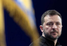 Person with short hair next to blurred yellow flag