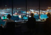 Air traffic controllers working at night airport tower