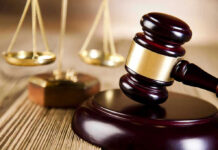 UK’s Youth Radicalization: A Growing Threat Wooden gavel and scales of justice on table