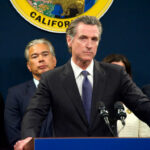 UNBELIEVABLE Timing: Newsom Attacks Israel MID-BATTLE Person speaks at podium with California seal behind.