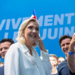 Group taking selfie with smiling woman at event