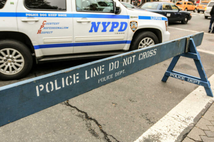 police-line-do-not-cross-barrier-set692777989jpg NYPD police barricade on city street with vehicles