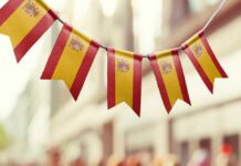 Bunting featuring the Spanish flag hanging in an outdoor setting