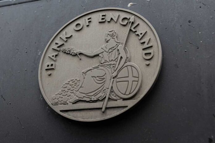 shutterstock_2341386899.jpg Emblem of the Bank of England featuring a seated figure with a spear and shield