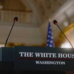 Podium with microphones at the White House for a press conference