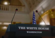 Podium with microphones at the White House for a press conference