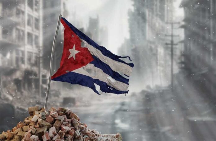 Worn Cuban flag standing on rubble in a desolate urban environment