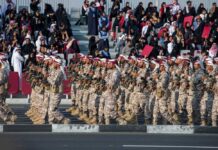 Qatar Scrambles F-15s—Gulf Neutrality Shatters Soldiers in military uniforms marching in a parade with a crowd in the background
