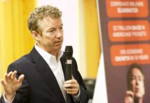 A man speaking into a microphone at a public event