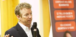 A man speaking into a microphone at a public event
