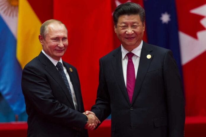 Two international leaders shaking hands at a diplomatic event