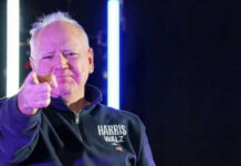 Man pointing with neon lights behind him