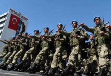 Soldiers marching in formation with blue berets