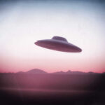 UFO flying over mountains during sunset or sunrise
