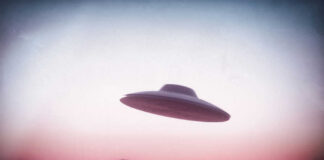 UFO flying over mountains during sunset or sunrise