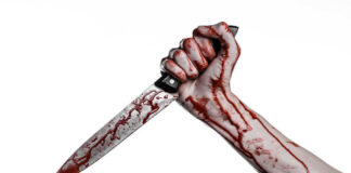 Bloody hand holding blood-stained knife.