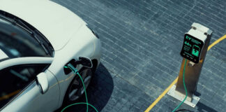 Electric vehicle charging at a public charging station.