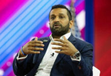 Person speaking on stage with colorful background