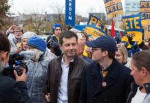A political candidate surrounded by supporters at a rally
