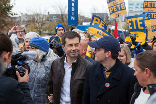 shutterstock_1550056004.jpg A political candidate surrounded by supporters at a rally