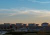 Oil storage tanks against a sunset sky