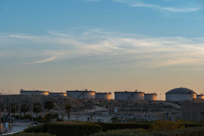 Oil storage tanks against a sunset sky