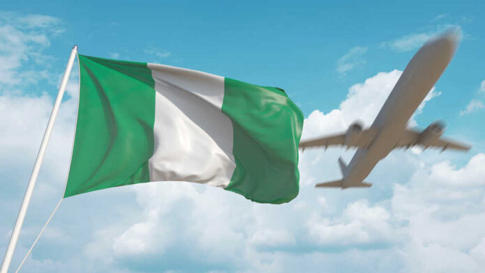 Nigerian flag waving with an airplane flying in the background