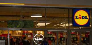 Entrance of a Lidl grocery store with customers shopping