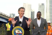California governor speaking at a construction site with smiling attendees