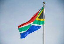 Afrikaners’ Surprising Stand – Reject U.S. Resettlement South African flag waving against a clear sky