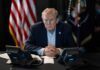 Republicans Unite: Trump’s Shutdown-Proof Strategy A serious-looking man seated at a table with phones and an American flag in the background