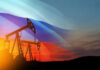 UK’s Quiet Sanctions Shift: Russian Fuel Re-Entry? Oil pumps silhouetted against Russian flag and sunset.
