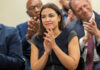 Woman clapping at an indoor event