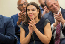 Woman clapping at an indoor event