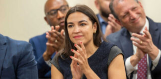 Woman clapping at an indoor event