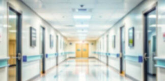 Blurred hospital corridor with doors and lights