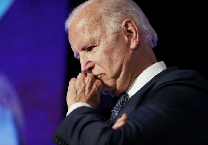 joe-biden-pauses-while-speaking2509411307jpg elderly man in suit resting chin on hand in thought
