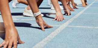 Athletes at starting line on blue track race