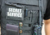 Security SNAFU: How Bureaucracy Endangers Presidents Close-up of a tactical vest worn by a security officer with 'SECRET SERVICE' label
