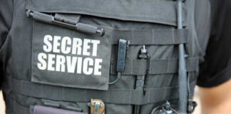 Close-up of a tactical vest worn by a security officer with 'SECRET SERVICE' label
