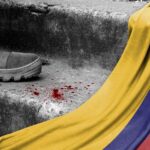 Right-Wing Targets: Colombia’s Dangerous Election Game A military boot on concrete steps with blood stains and a Colombian flag draped nearby