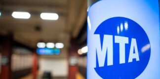 MTA sign in a subway station with blurred background
