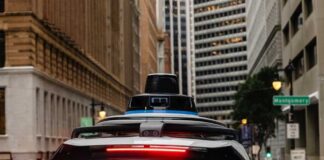 Rear view of a Waymo autonomous vehicle on a city street