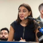 AOC’s Dramatic Brown Water Reveal Stuns EPA Person drinking water from a blue outdoor faucet