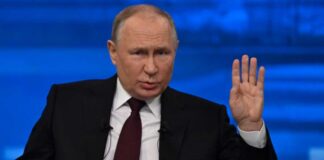 A political leader gesturing during a press conference