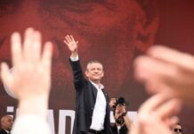 Person waving Turkish flag in a crowd