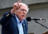 Sanders Backs Platner in Maine Senate Race During “Fighting Oligarchy” Tour A man passionately speaking at a microphone during a public rally