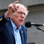 Sanders Backs Platner in Maine Senate Race During “Fighting Oligarchy” Tour A man passionately speaking at a microphone during a public rally