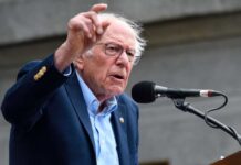 Sanders Backs Platner in Maine Senate Race During “Fighting Oligarchy” Tour A man passionately speaking at a microphone during a public rally